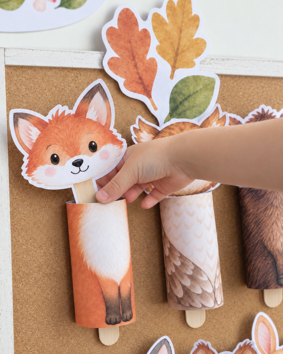 Child’s hand putting the fox head into the matching roll