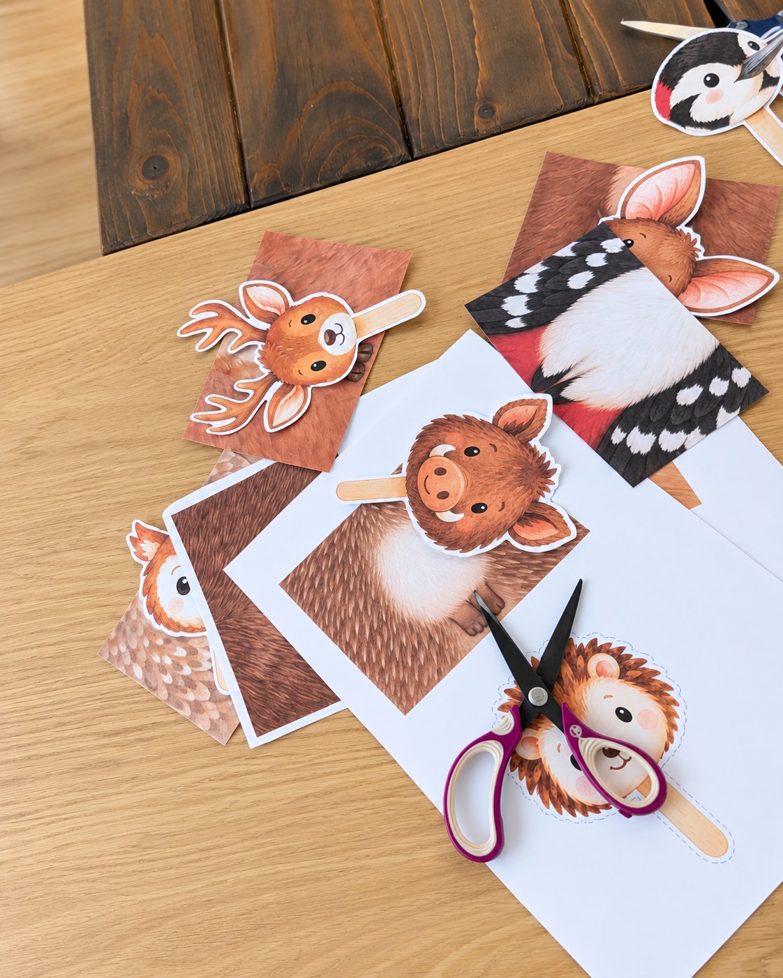 Cutting out the forest animals with scissors